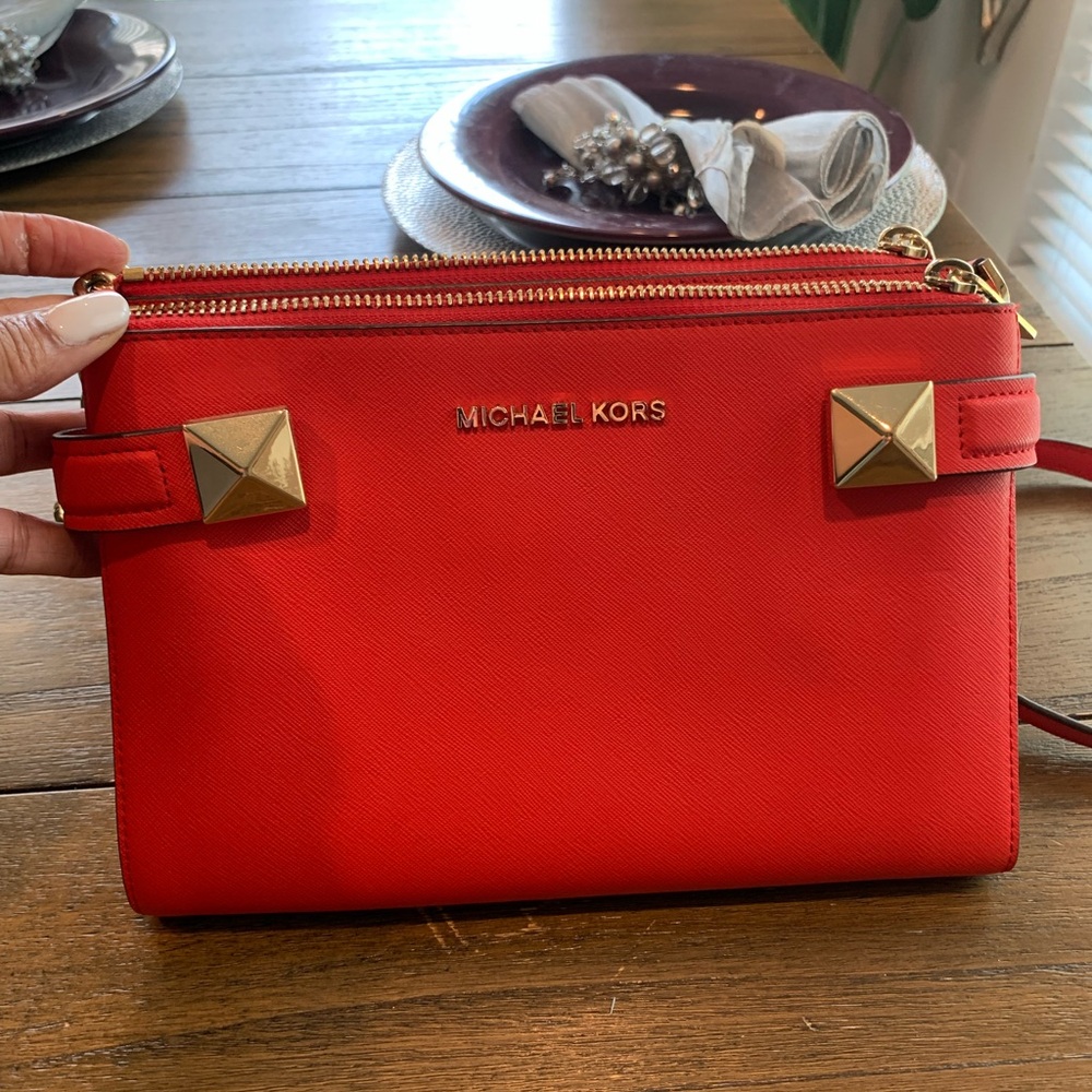 Red leather Micheal kors crossbody purse.